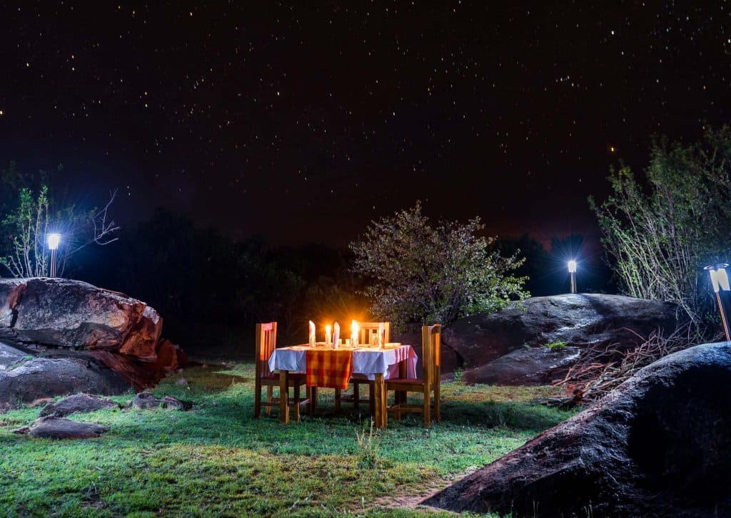 A table set for drinks in the bush as the light goes