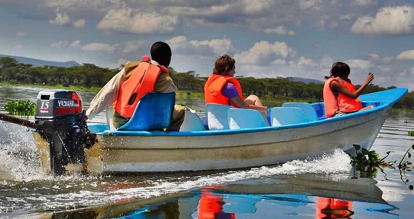 A small boat on Lake Naivasha among hippos and waterbirds
